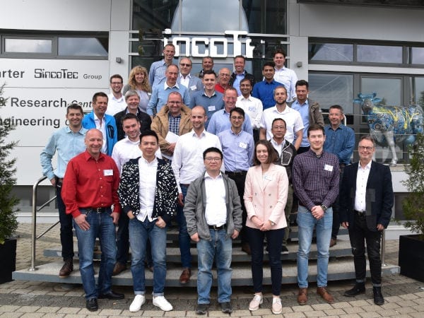 International group photo in front of the SincoTec main building.