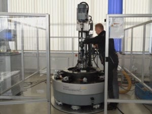 A man works on a testing machine in the laboratory.